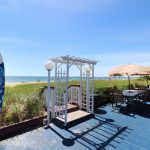 Surfboard shower, beach entrance and picnic tables
